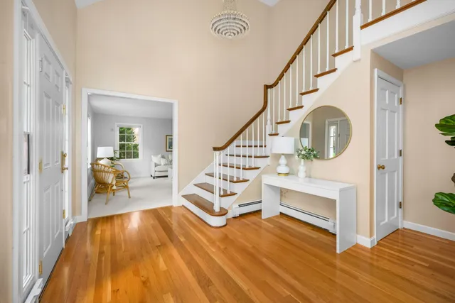 a view of entryway and hall with wooden floor