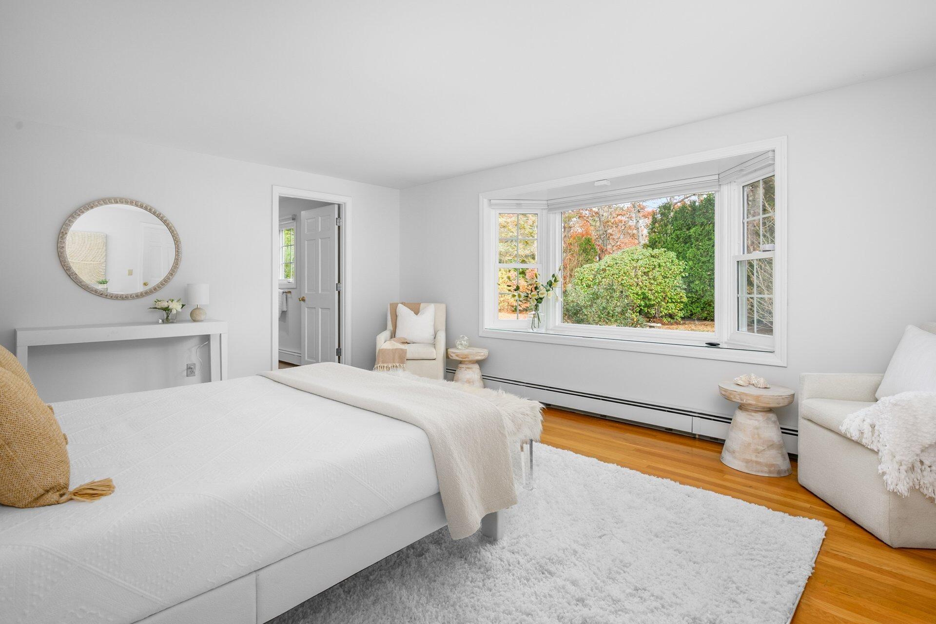 239 Clamshell Cove Road Cotuit, MA 02635 - Photo 15 of 30 a bedroom with a bed and a large window