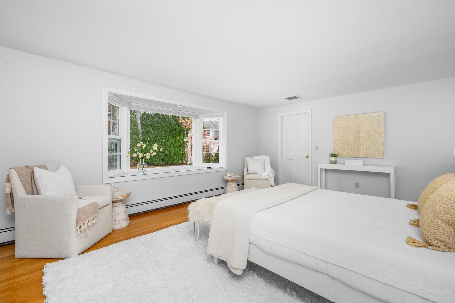 239 Clamshell Cove Road Cotuit, MA 02635 - Photo 16 of 30 a bedroom with a bed and a large window