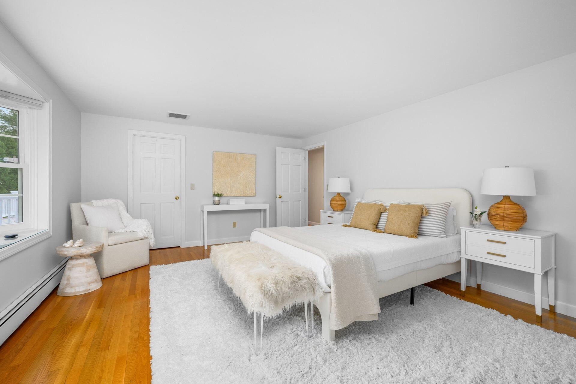 239 Clamshell Cove Road Cotuit, MA 02635 - Photo 17 of 30 a bedroom with a bed and lamp