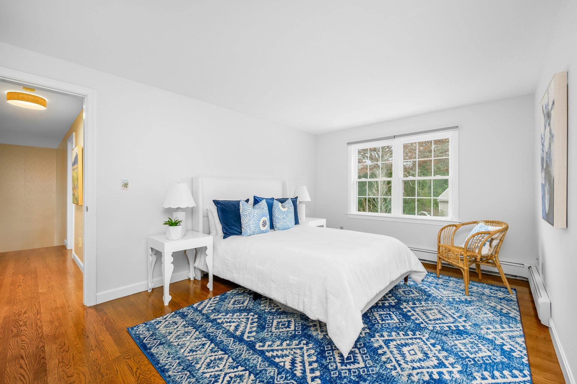 239 Clamshell Cove Road Cotuit, MA 02635 - Photo 19 of 30 a bed room with a bed and a chair