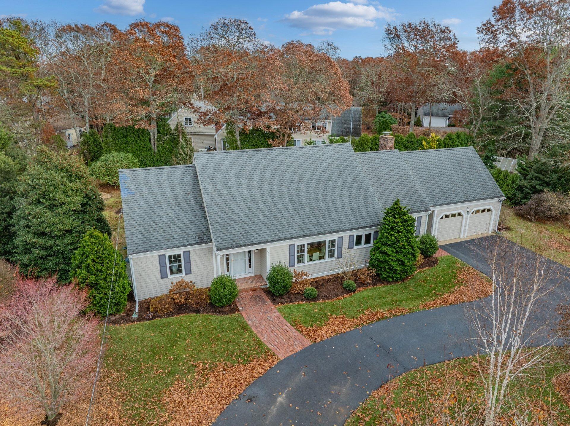 239 Clamshell Cove Road Cotuit, MA 02635 - Photo 2 of 30 an aerial view of a house with a yard and large trees
