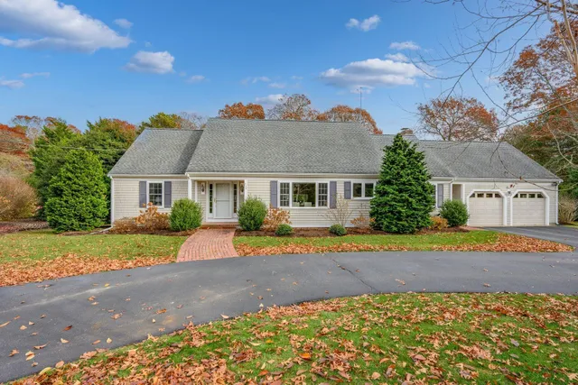 a front view of a house with a yard and a garage