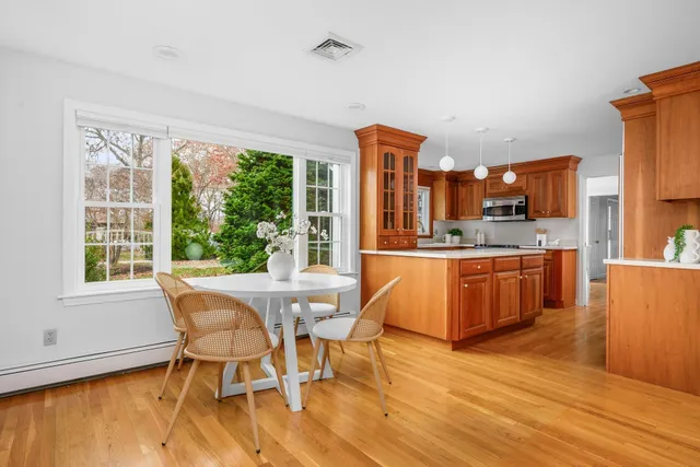 a view of a dining room with furniture window and wooden floor