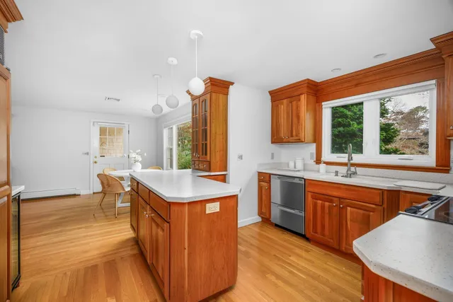 a kitchen with a sink and wooden cabinets