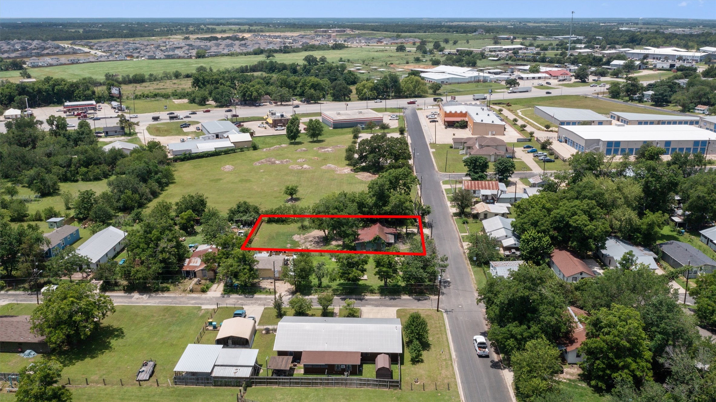 503 West Alamo Street Elgin, TX 78621 - Photo 2 of 11 an aerial view of a city with lots of residential buildings ocean and mountain view in back
