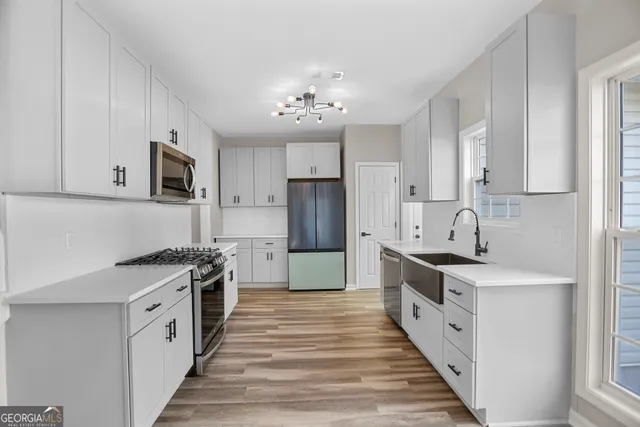 a kitchen with stainless steel appliances a stove top oven