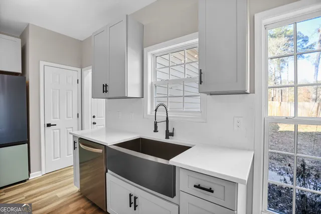 a kitchen with a sink cabinets and window