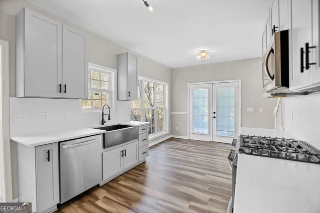 a kitchen with stainless steel appliances a sink and cabinets