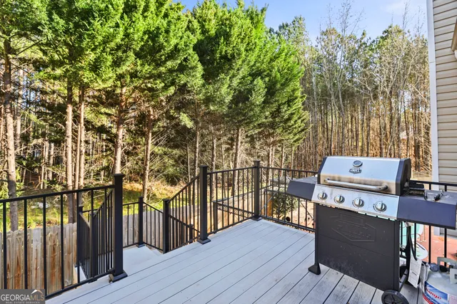 a view of a balcony with wooden floor and fence
