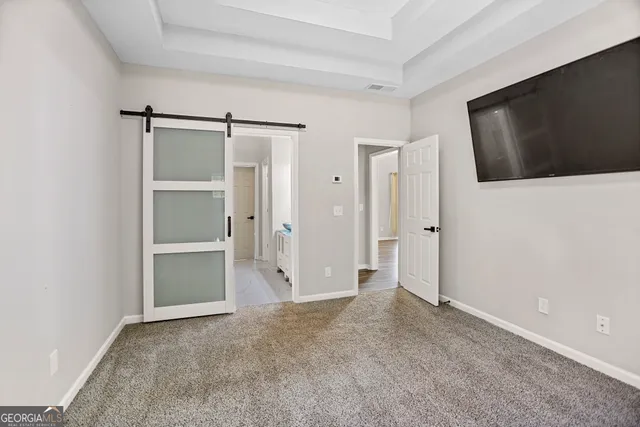 a view of a livingroom with an empty space and wooden floor