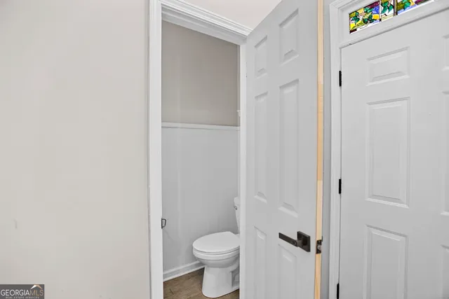 a white toilet sitting next to a shower curtain