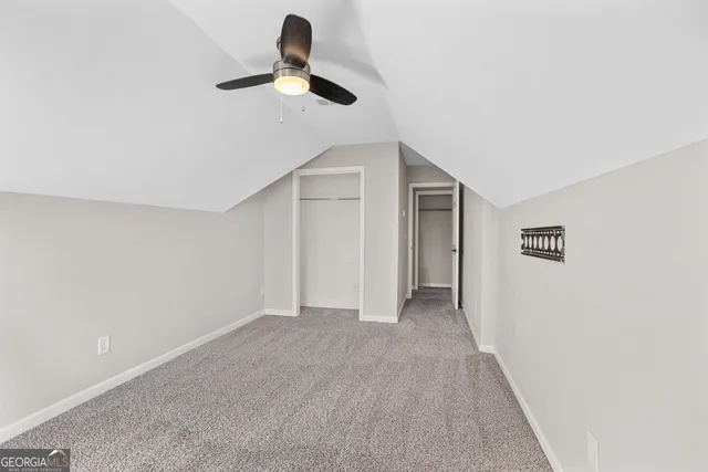 a view of empty room with ceiling fan