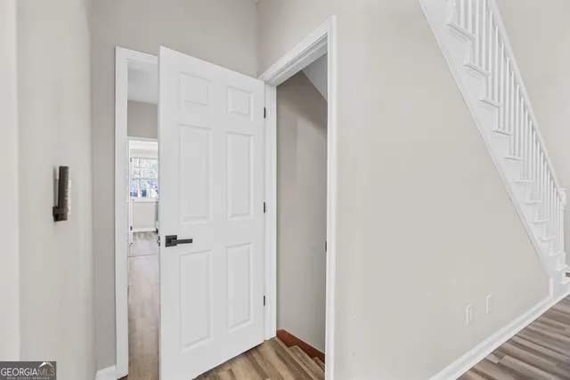 a view of a hallway with wooden floor