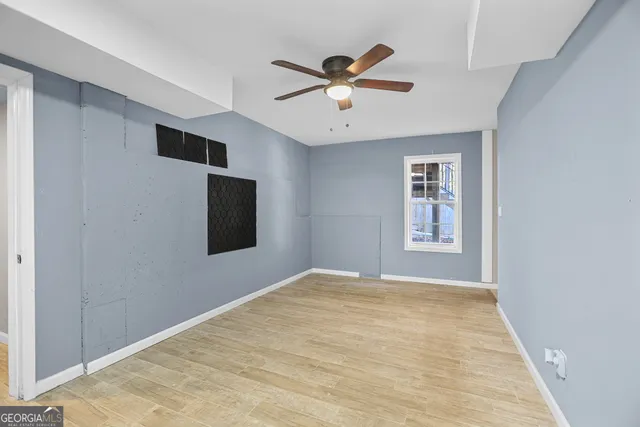 a view of a livingroom with a ceiling fan and a window