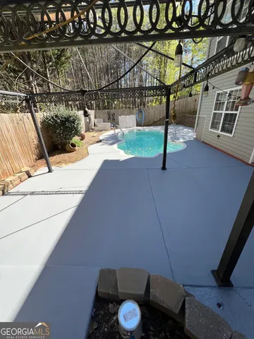 a backyard of a house with table and chairs