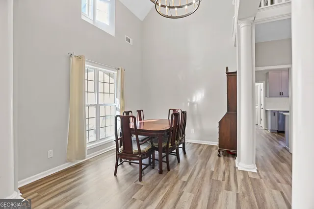 a view of a dining room with furniture and wooden floor