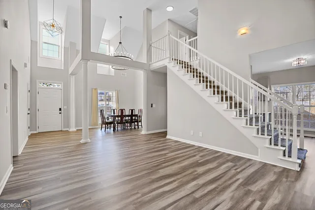 a view of entryway and hall with wooden floor