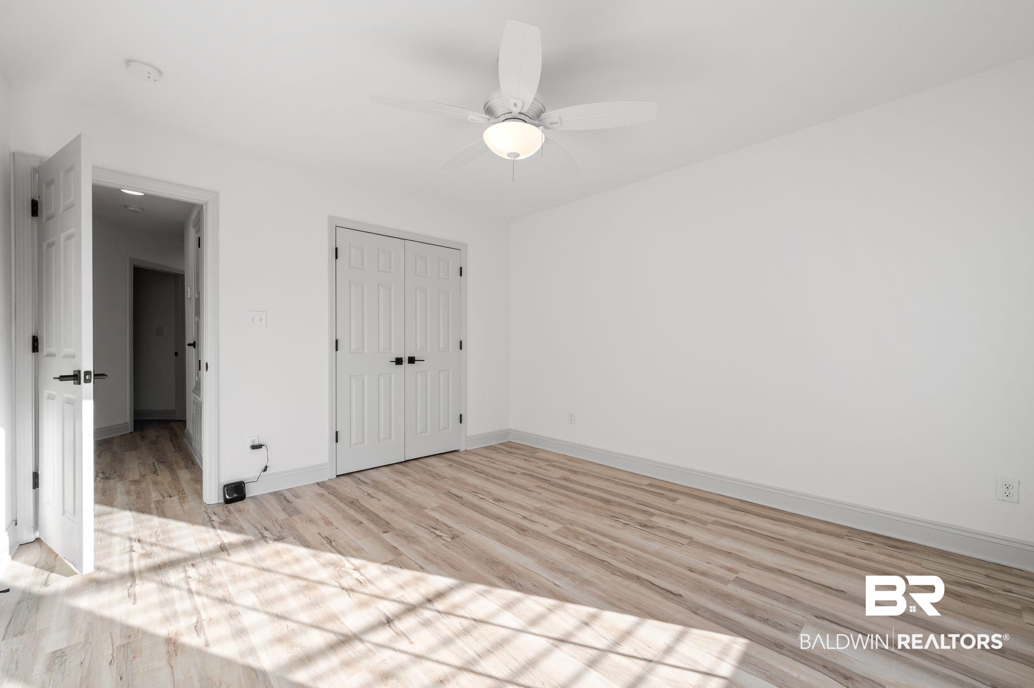 136 Destrehan Road Fairhope, AL 36532 - Photo 17 of 44 Unfurnished bedroom featuring a closet, light wood-type flooring, and ceiling fan