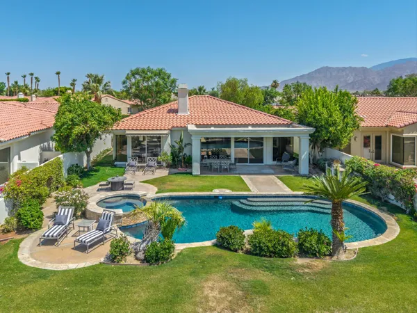 a view of a house with swimming pool and porch