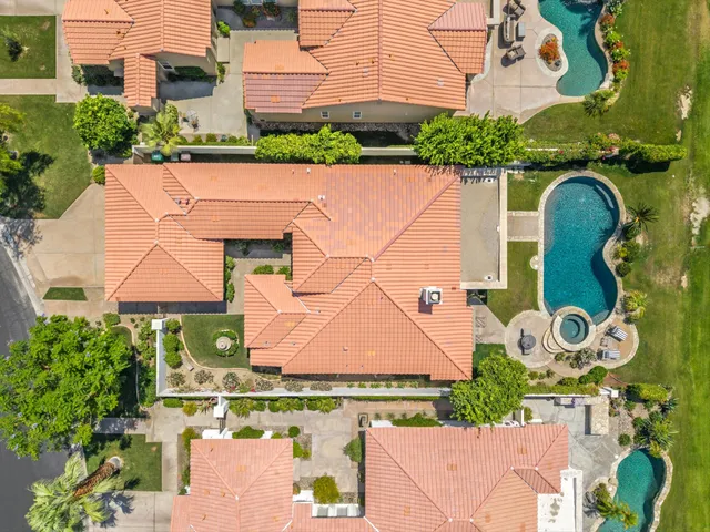 an aerial view of a house with a swimming pool