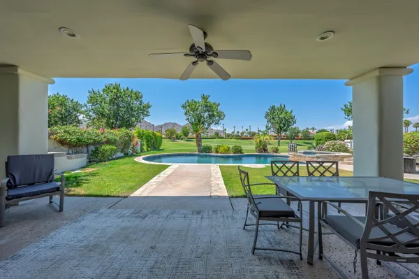 a view of an chairs and table in the patio
