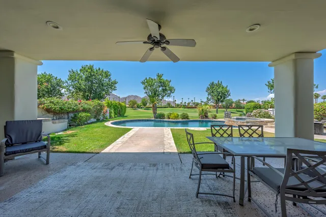 a view of an chairs and table in the patio