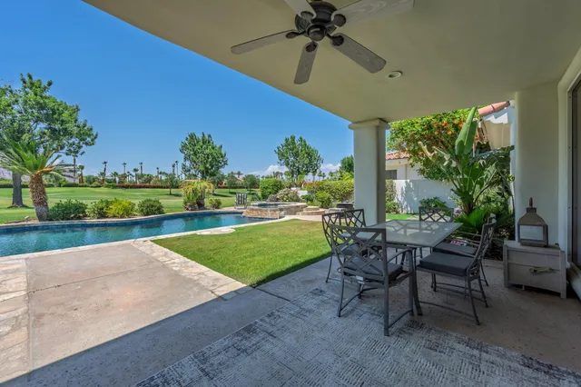 a view of a patio with a table and chairs