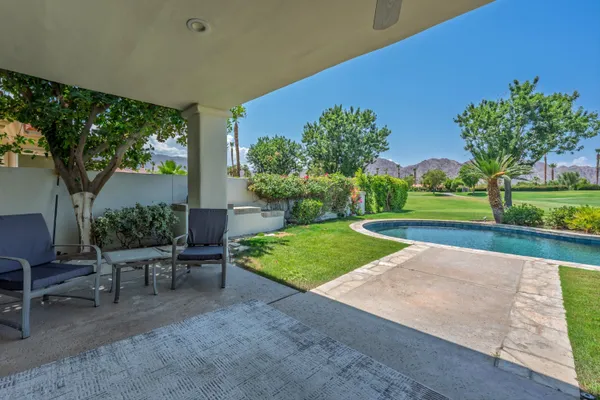 a view of a backyard with sitting area