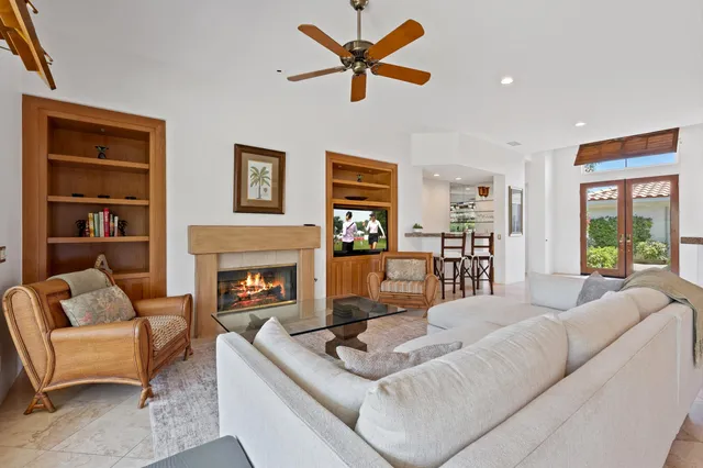 a living room with furniture fireplace and window
