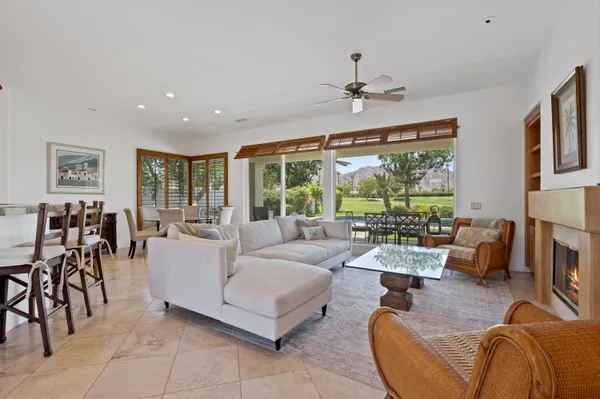 a living room with furniture large window and flat screen tv