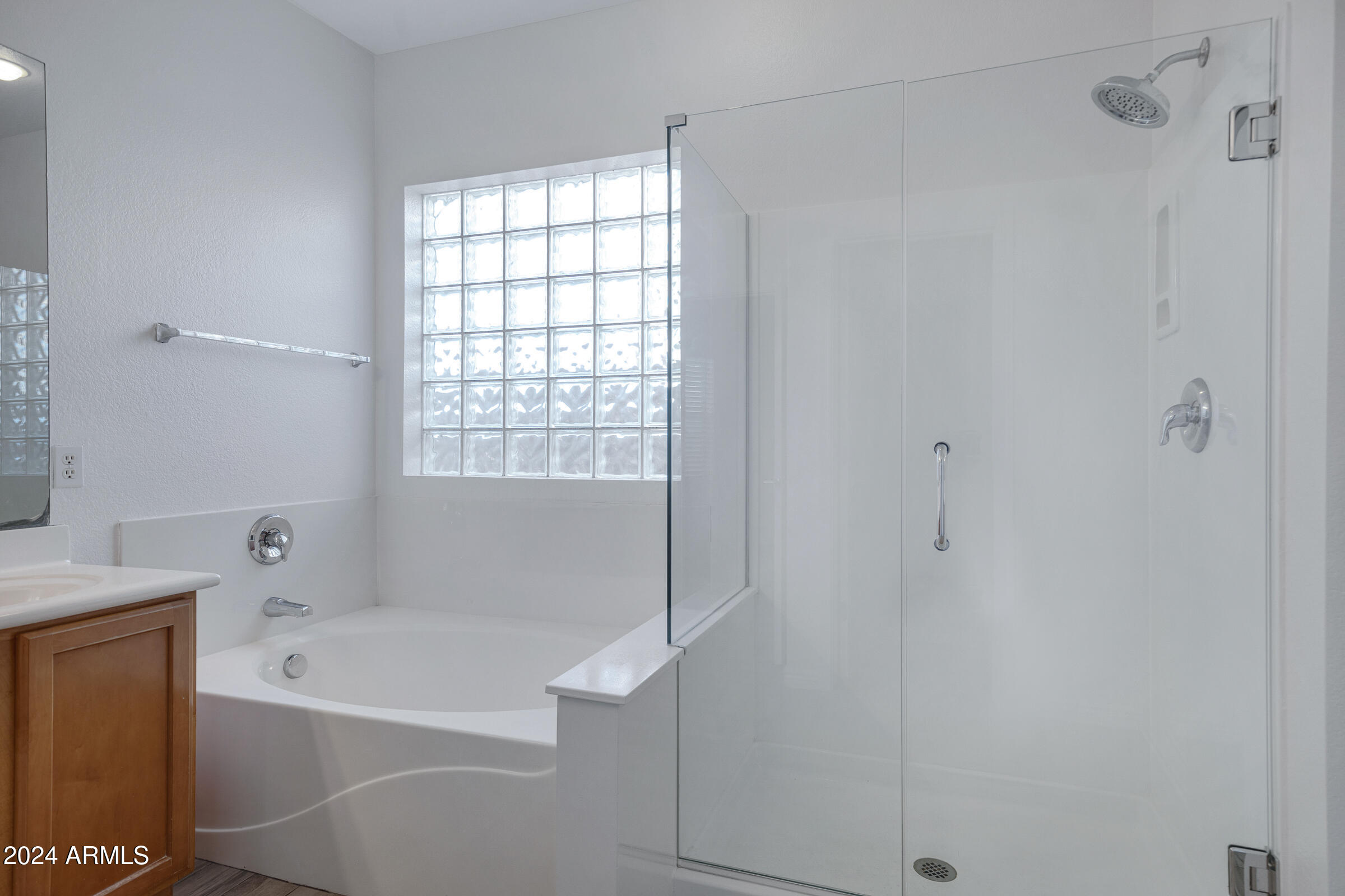 9310 West Berkeley Road Phoenix, AZ 85037 - Photo 24 of 31 a bathroom with a bathtub and a shower