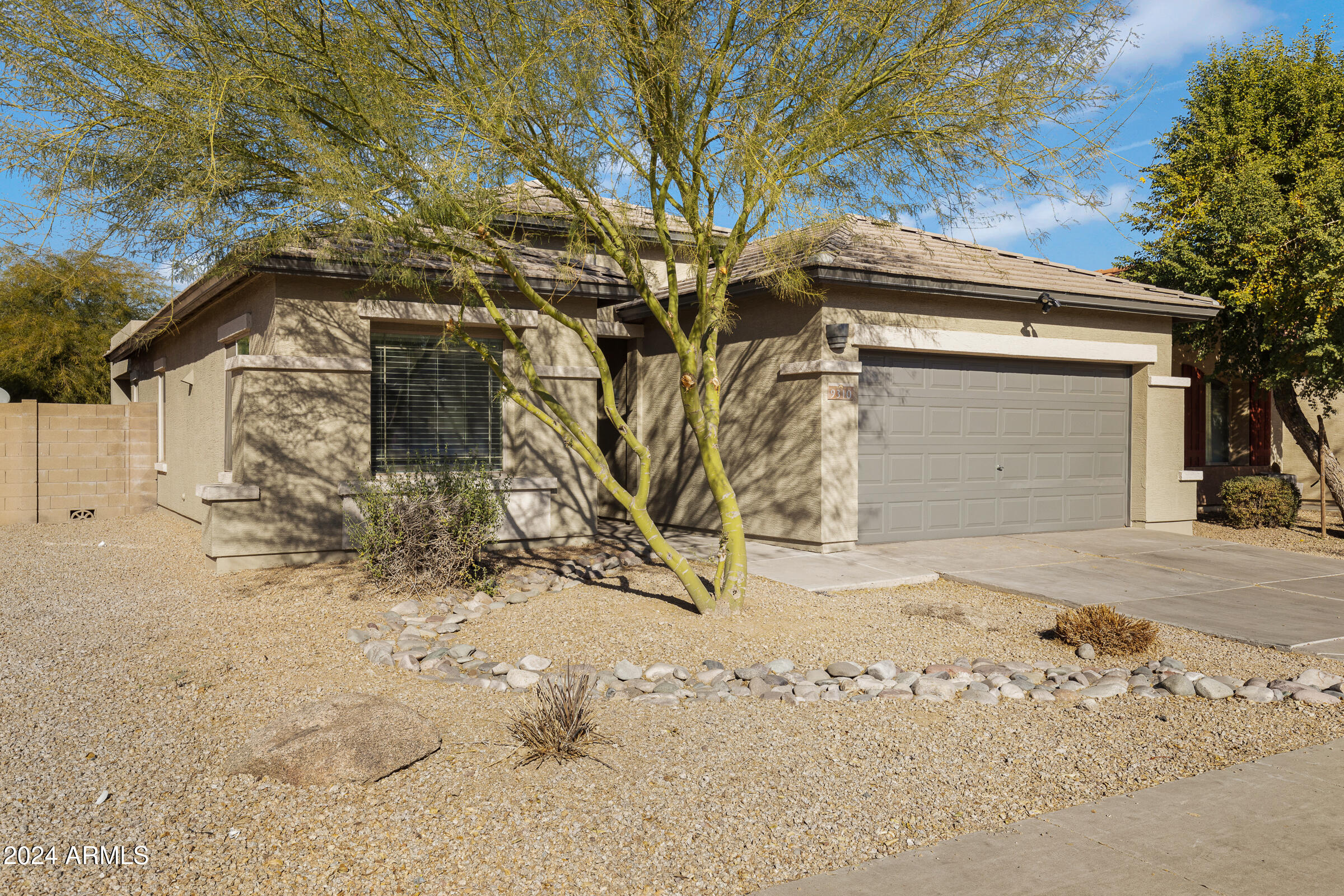 9310 West Berkeley Road Phoenix, AZ 85037 - Photo 3 of 31 a front view of a house with a yard and garage
