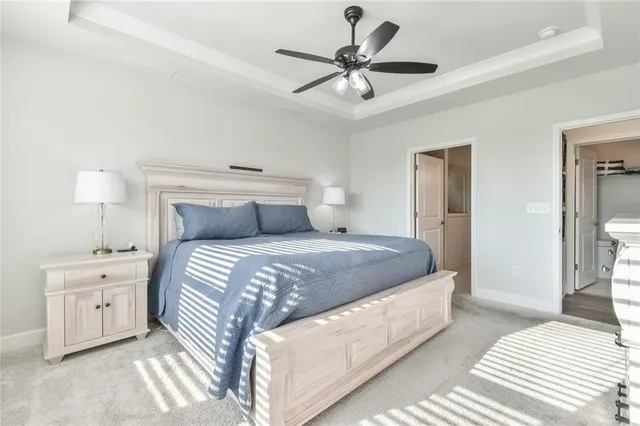 a living room with furniture chandelier and a dining table with wooden floor