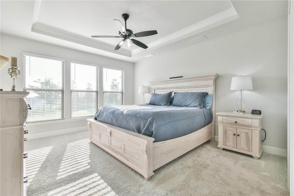 5051 Adler Court Hoschton, GA 30548 - Photo 16 of 41 a bedroom with a large bed and a large window