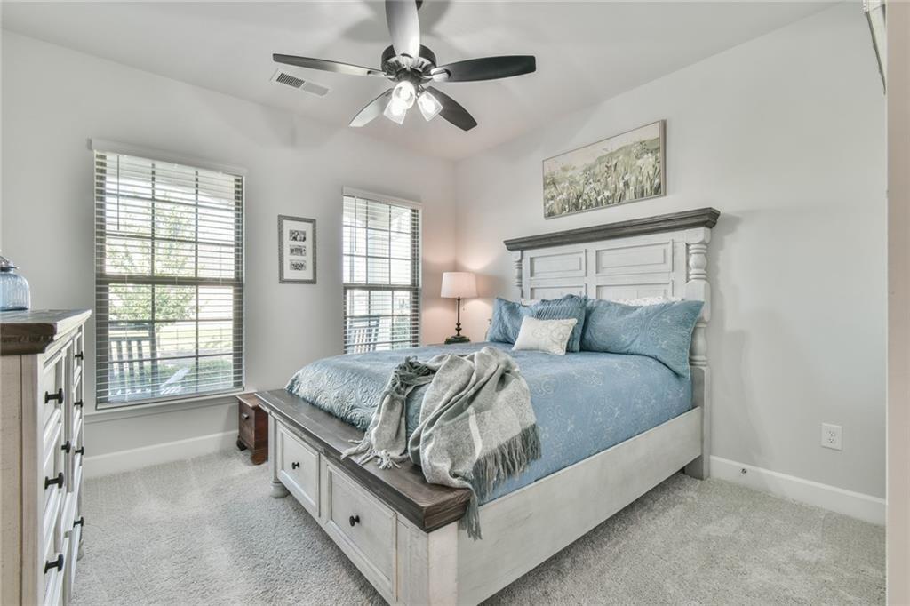 5051 Adler Court Hoschton, GA 30548 - Photo 21 of 41 a bed sitting in a spacious bedroom next to a window