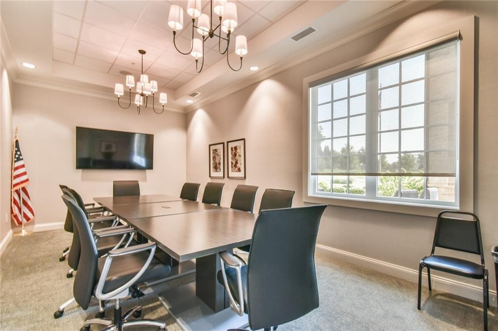 5051 Adler Court Hoschton, GA 30548 - Photo 33 of 41 a view of a dining room with furniture window and wooden floor