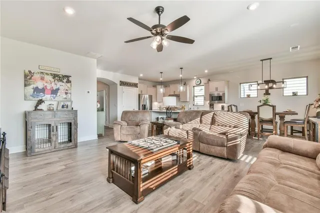 a living room with furniture and wooden floor