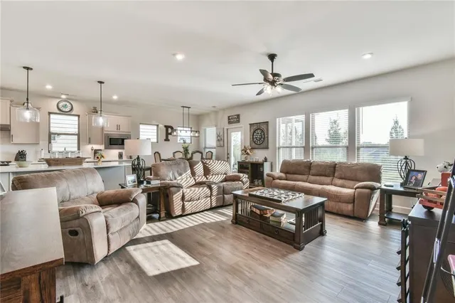 a kitchen with cabinets stainless steel appliances a sink and wooden floor