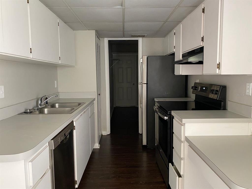 2858 Southwest 39th Avenue Gainesville, FL 32608 - Photo 2 of 12 a kitchen with a sink a stove and refrigerator