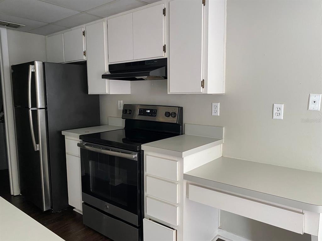 2858 Southwest 39th Avenue Gainesville, FL 32608 - Photo 3 of 12 a kitchen with stainless steel appliances a stove microwave and refrigerator
