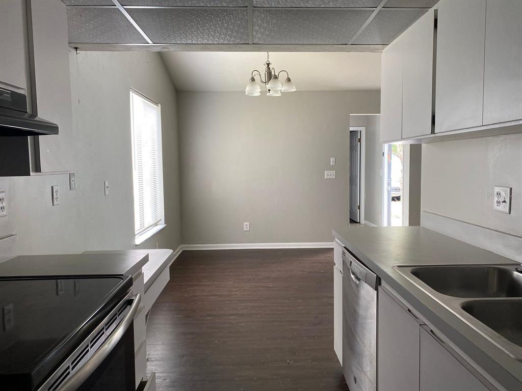 2858 Southwest 39th Avenue Gainesville, FL 32608 - Photo 5 of 12 a kitchen with granite countertop a sink cabinets and stainless steel appliances