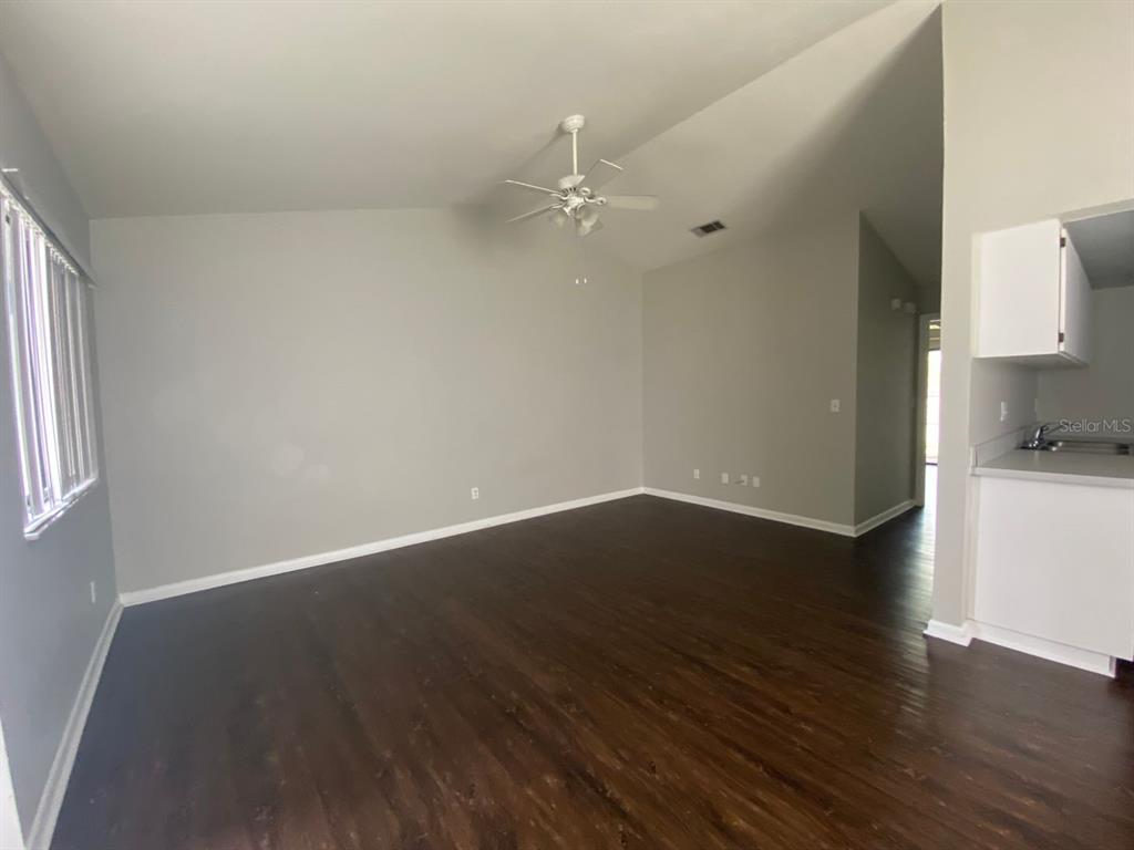 2858 Southwest 39th Avenue Gainesville, FL 32608 - Photo 6 of 12 wooden floor in an empty room with a window
