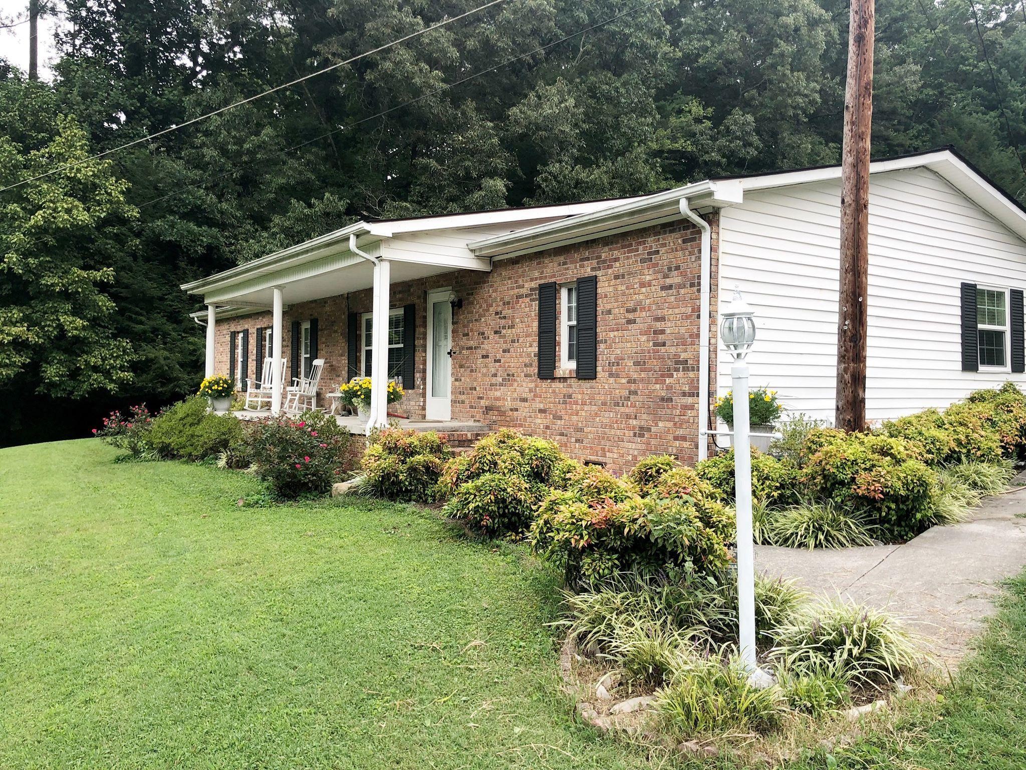 159 Foust Hollow Road Heiskell, TN 37754 - Photo 1 of 16 a view of a house with backyard and garden
