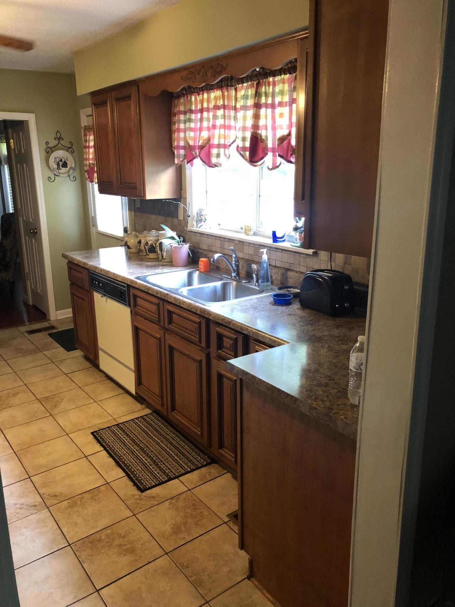 159 Foust Hollow Road Heiskell, TN 37754 - Photo 4 of 16 a kitchen with stainless steel appliances a sink stove and a window