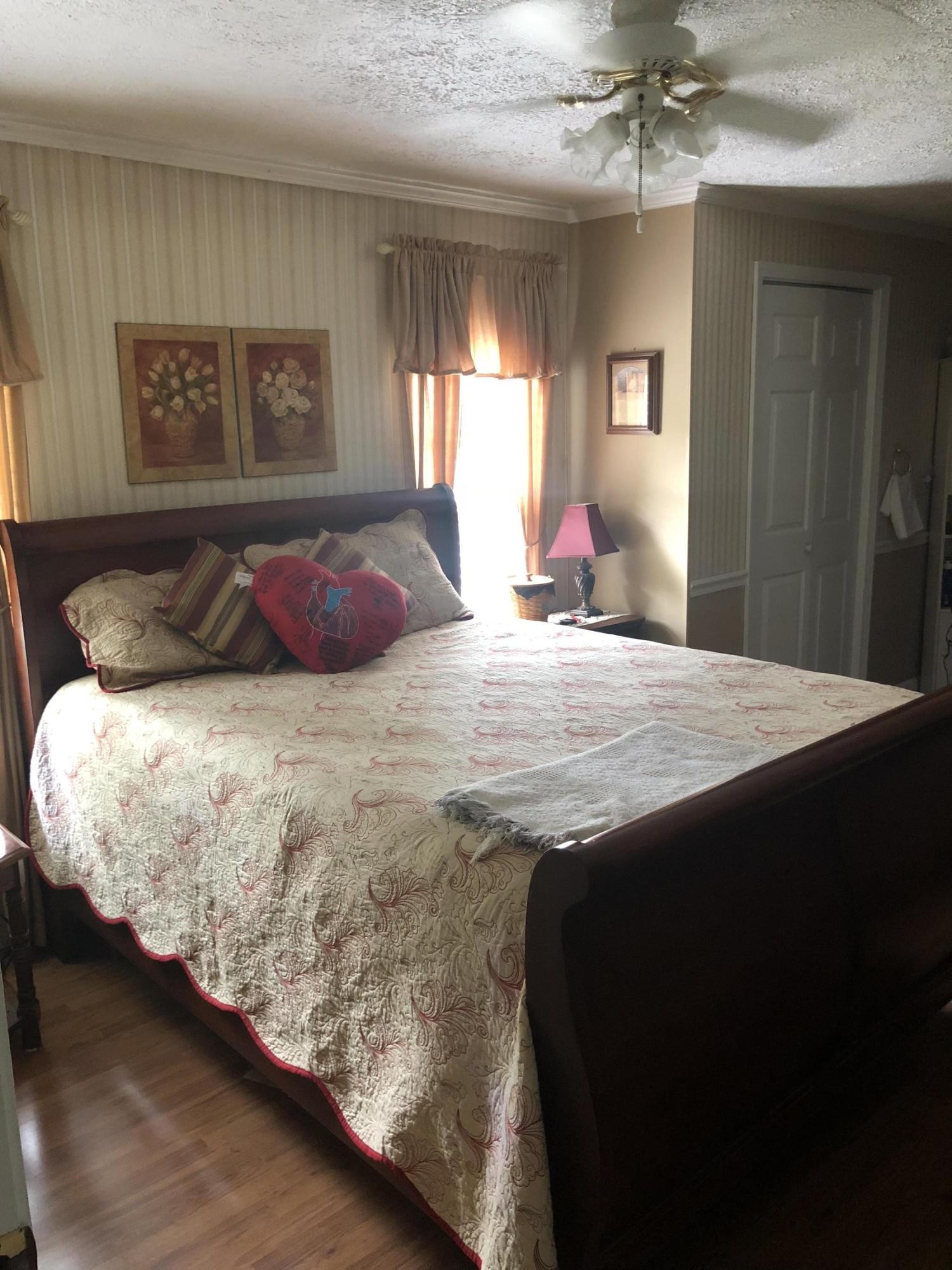 159 Foust Hollow Road Heiskell, TN 37754 - Photo 9 of 16 a bedroom with a large bed and a chandelier