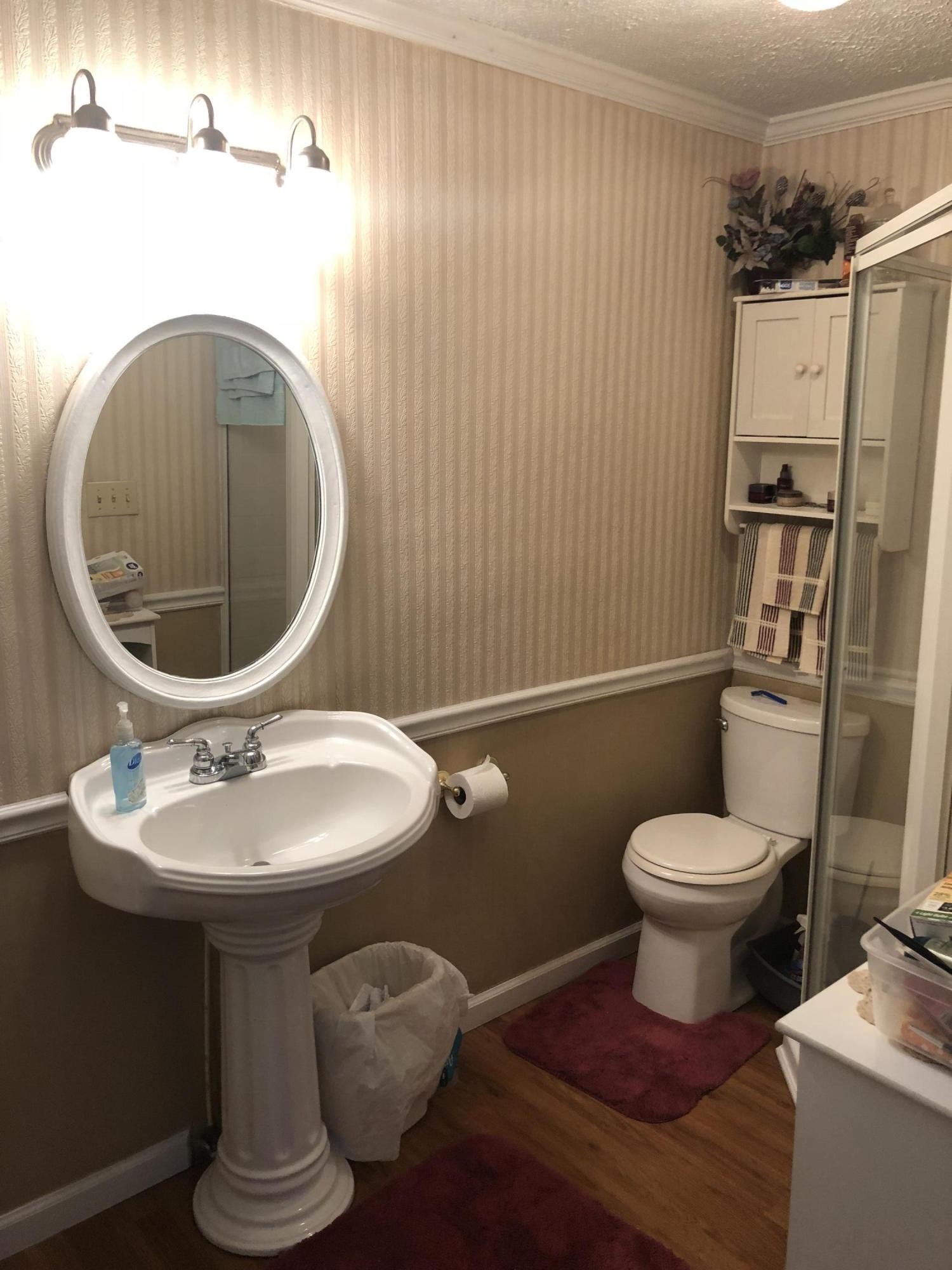159 Foust Hollow Road Heiskell, TN 37754 - Photo 10 of 16 a bathroom with a toilet sink and mirror
