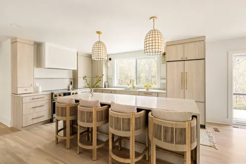 a dining room with furniture and a large window