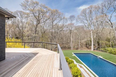 a view of a backyard with wooden fence