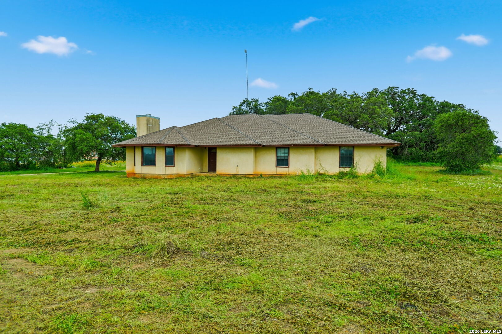 3061 Horse Ranch Road San Antonio, TX 78264 - Photo 26 of 34 a white house sitting in middle of the grass